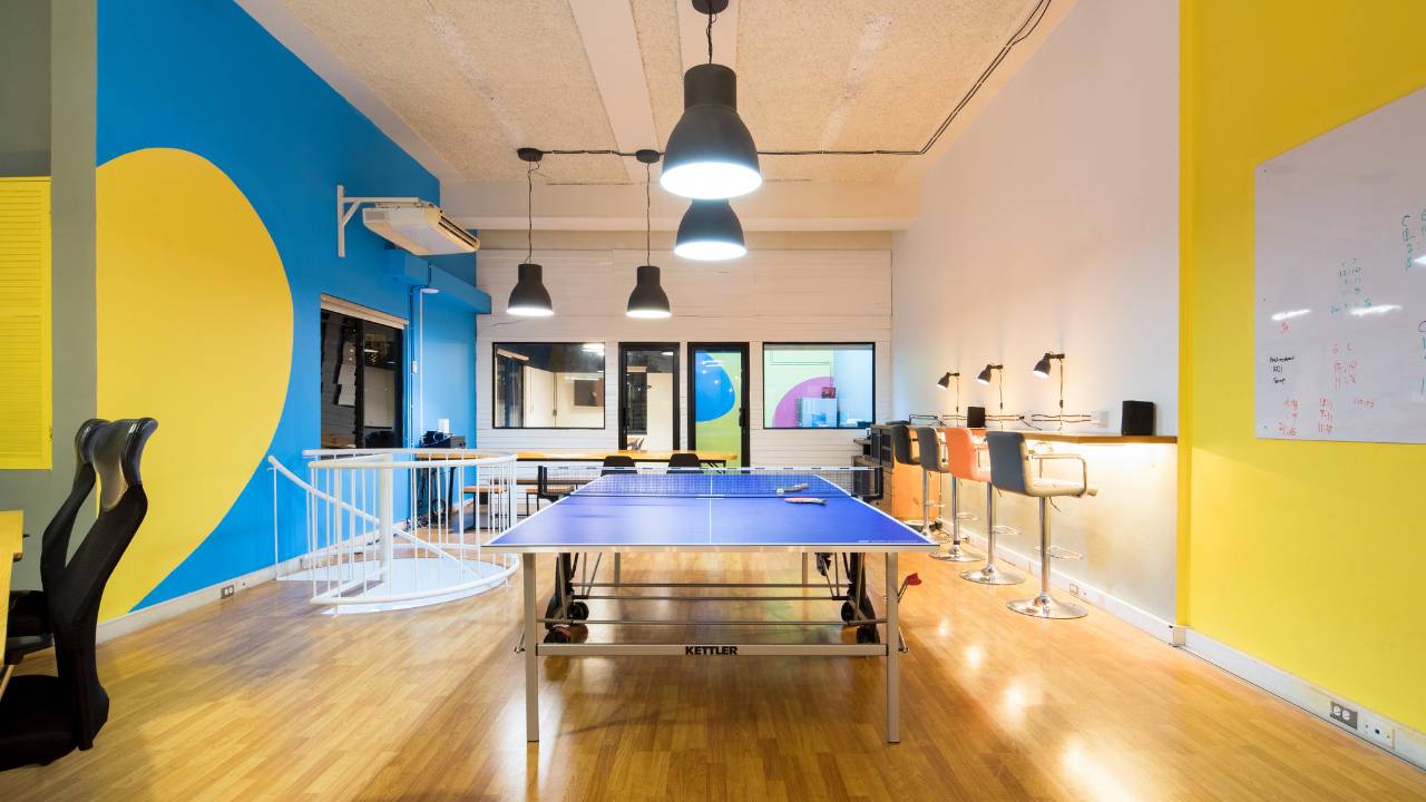 A table for table tennis in a colourful workspace